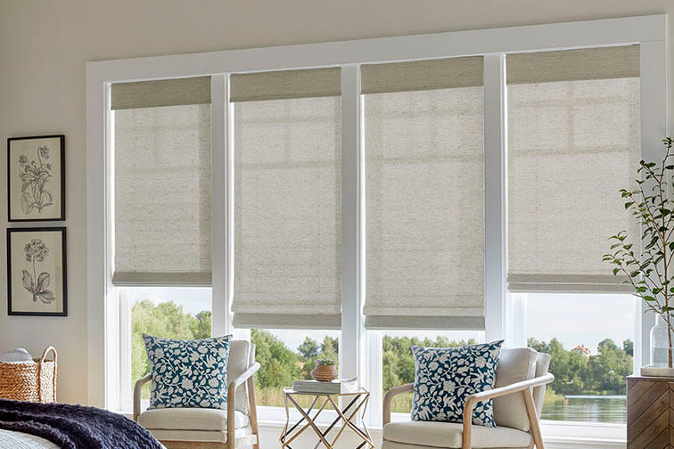 A white seating room with white shades made of natural materials.